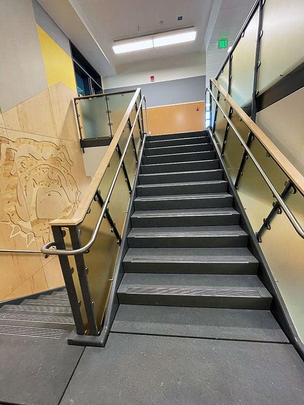 an interior stairway with handrails