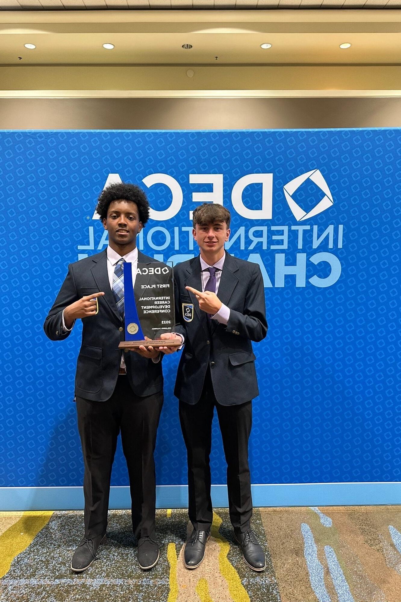 Students standing with award from DECA International Competition